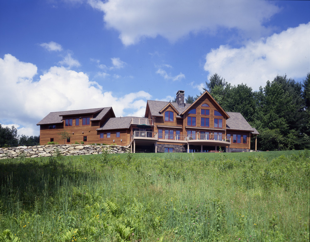 Inspiration for a huge rustic brown two-story wood gable roof remodel in Burlington