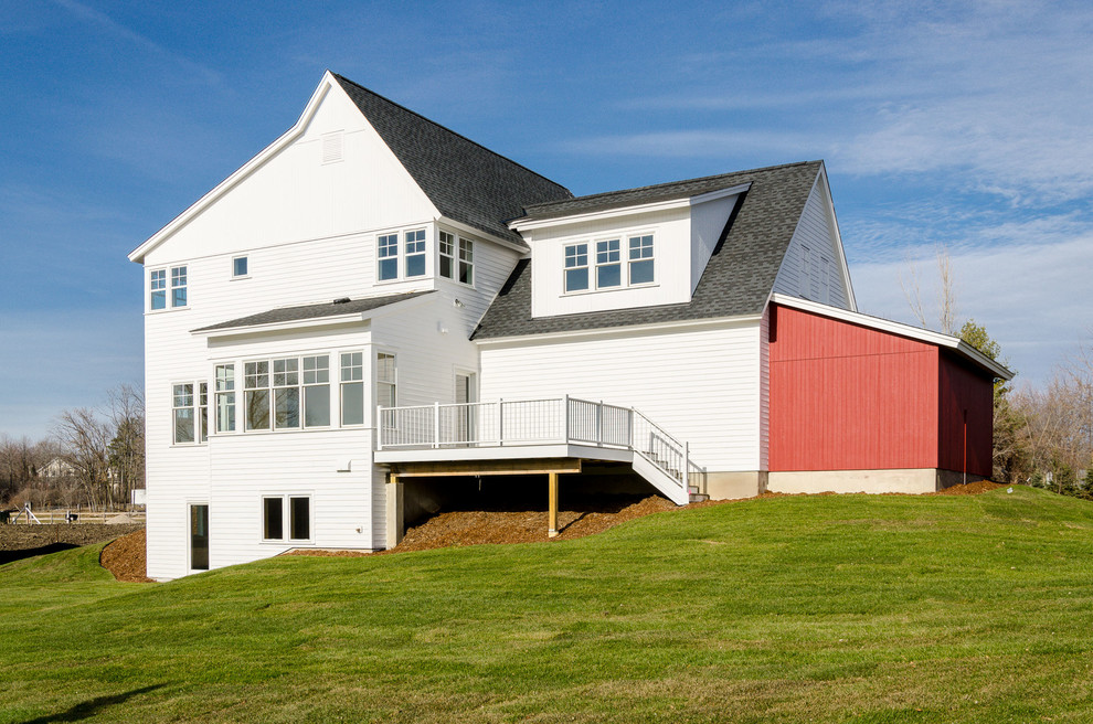 Large and white rural two floor house exterior in Minneapolis with wood cladding.