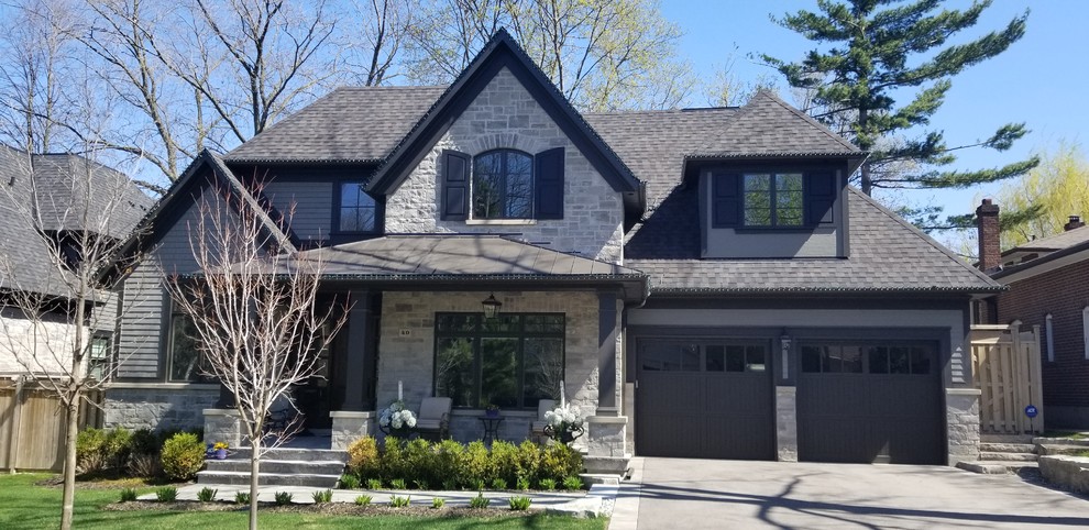 Large transitional gray two-story mixed siding exterior home photo in Toronto with a shingle roof