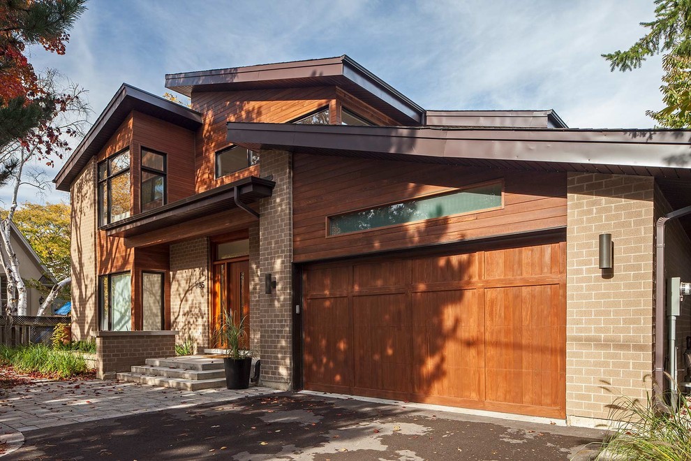 Example of a transitional wood exterior home design in Toronto