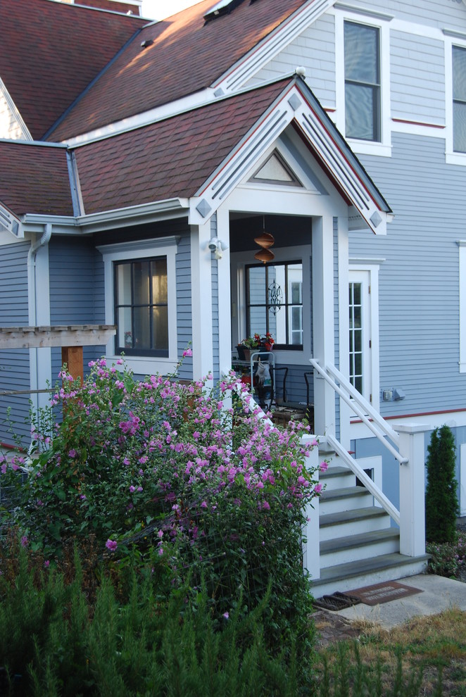 Example of a large ornate gray two-story wood exterior home design in Seattle with a shingle roof