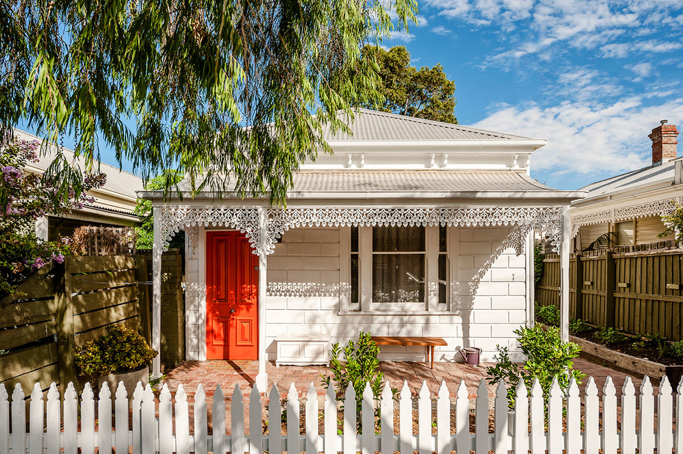 Design ideas for a small and white victorian bungalow brick house exterior in Melbourne with a hip roof.