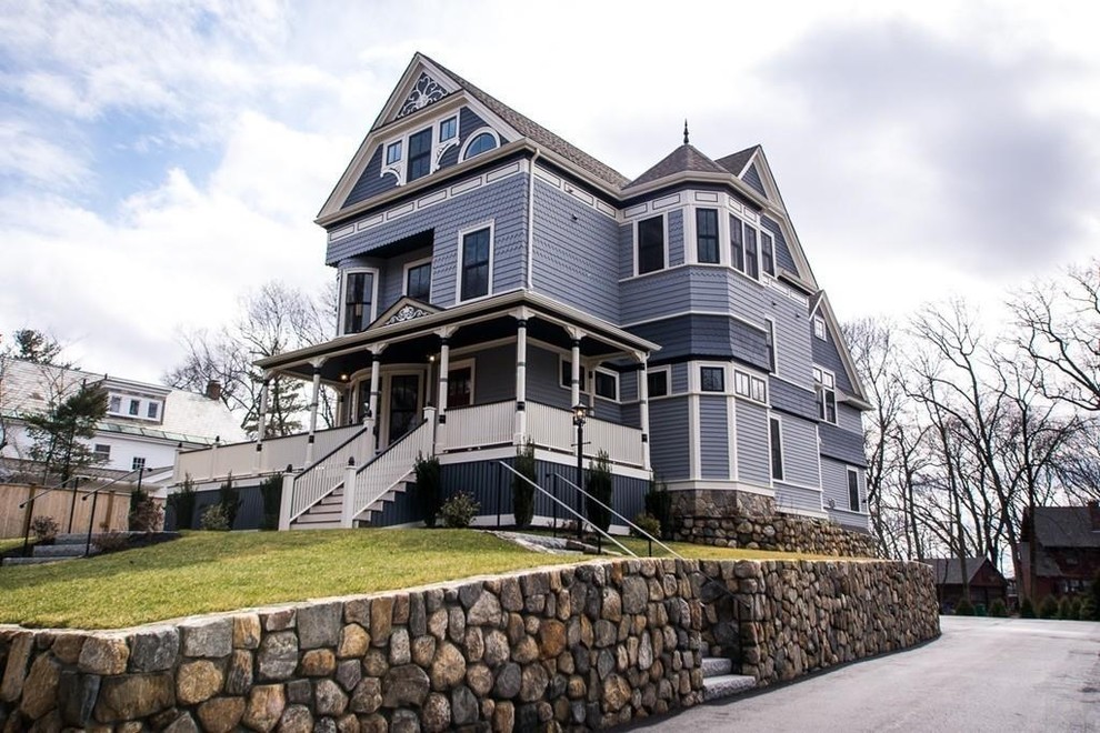 This is an example of a large and blue victorian detached house in Boston with three floors.