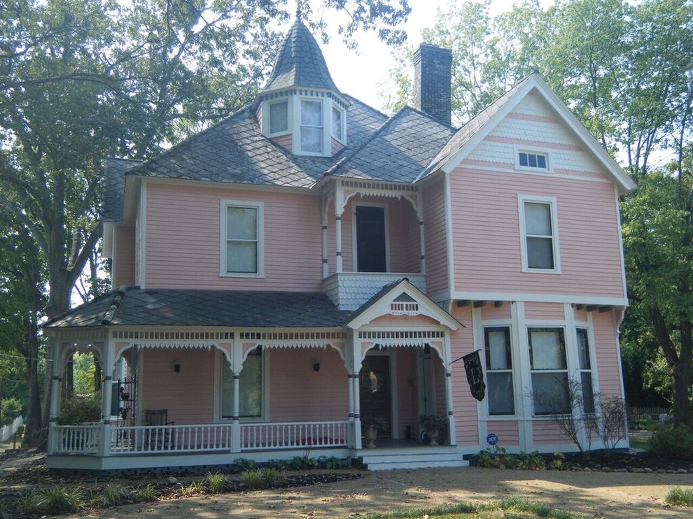 Cette image montre une façade de maison rose victorienne de taille moyenne et à deux étages et plus avec un revêtement en vinyle et un toit à deux pans.