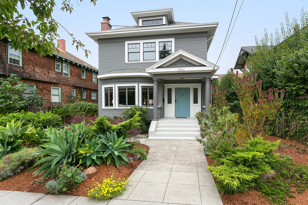 Mid-sized ornate gray two-story vinyl house exterior photo in San Francisco with a hip roof and a shingle roof