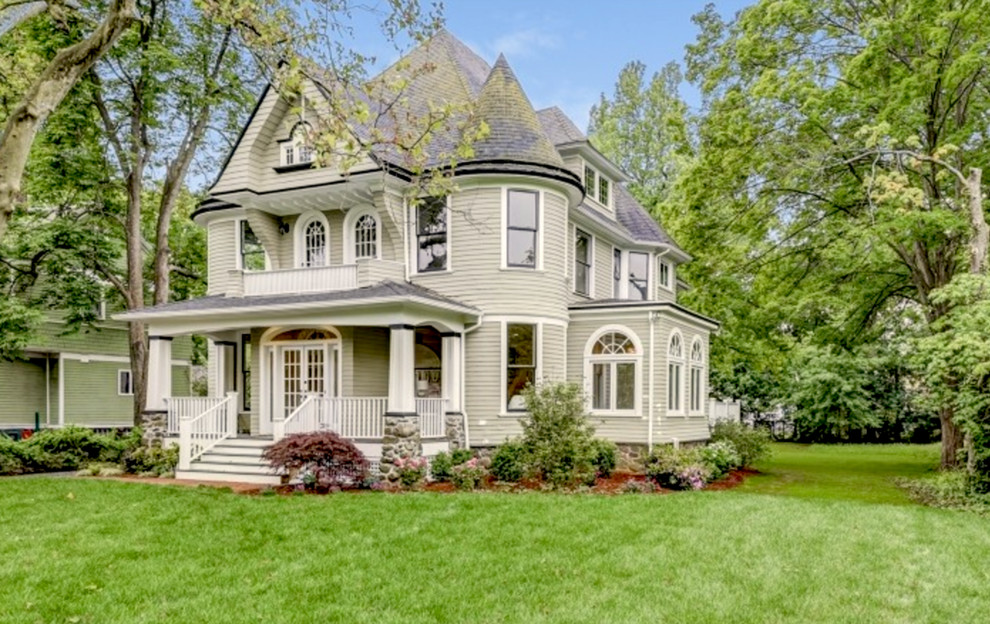 Huge victorian green three-story wood house exterior idea in Newark with a hip roof and a shingle roof