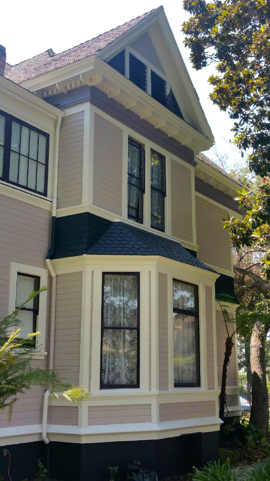 Example of an ornate two-story wood exterior home design in Los Angeles