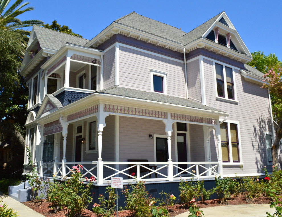 Inspiration for a victorian two floor house exterior in Los Angeles with wood cladding.
