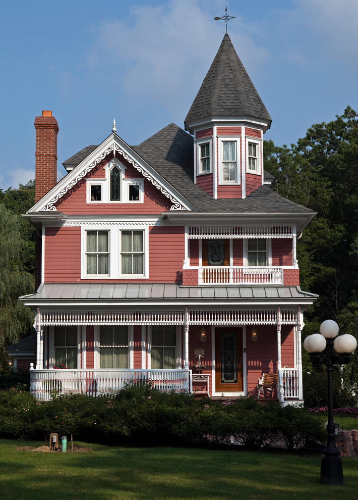 Inspiration for a mid-sized victorian red two-story wood gable roof remodel in Philadelphia