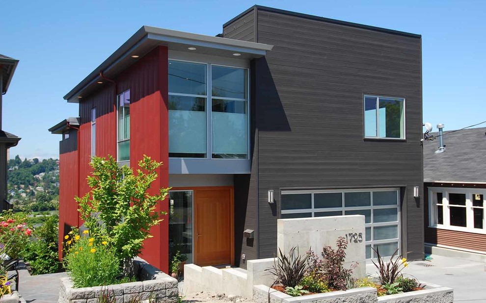 Réalisation d'une façade de maison métallique et noire minimaliste de taille moyenne et à un étage.