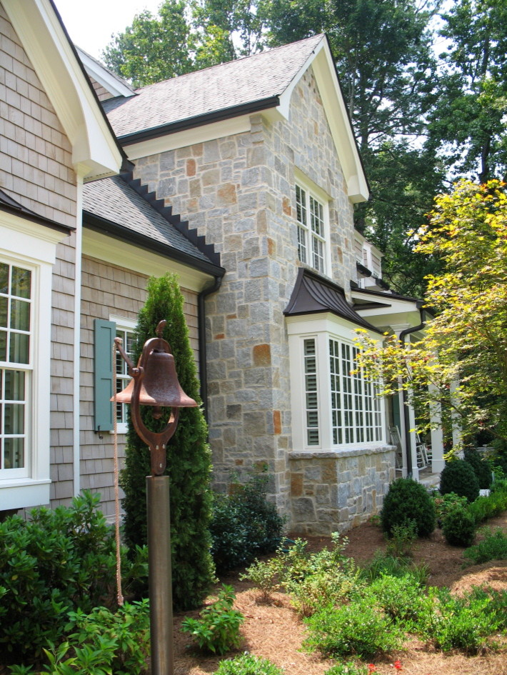 Example of a mid-sized classic gray two-story stone gable roof design in Atlanta