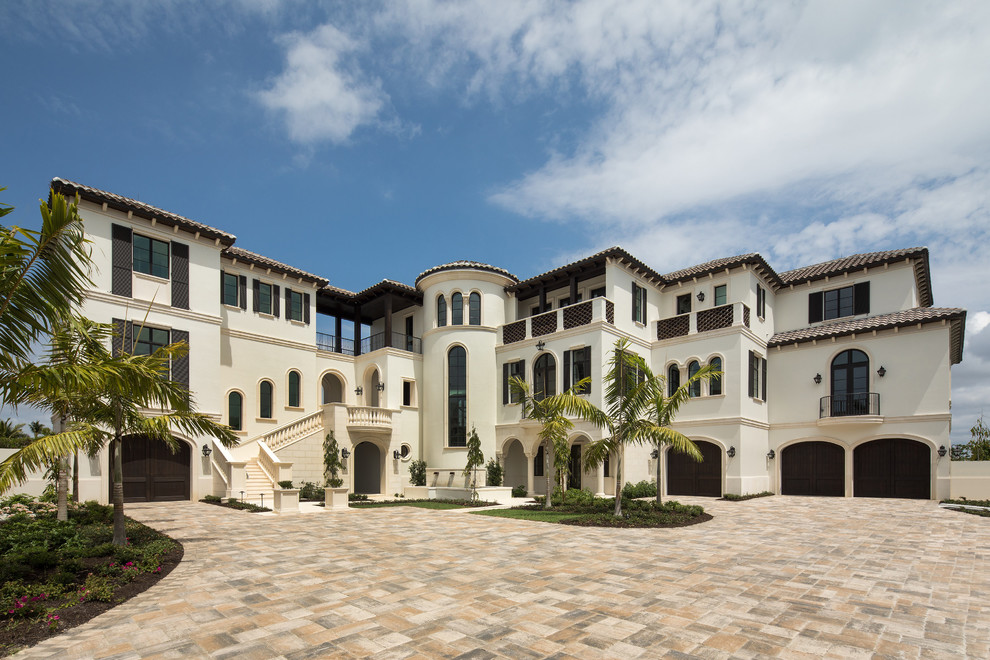 Huge tuscan white three-story stucco house exterior photo in Other with a tile roof and a hip roof
