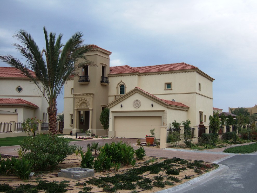 This is an example of a mediterranean two floor house exterior in Houston.
