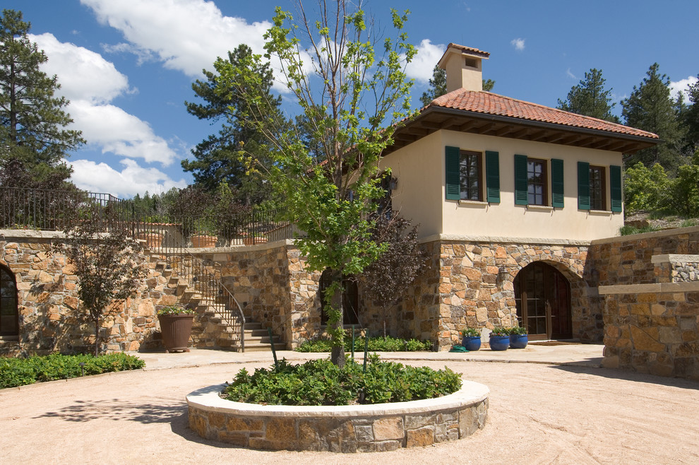 Mediterranean stone exterior home idea in Denver