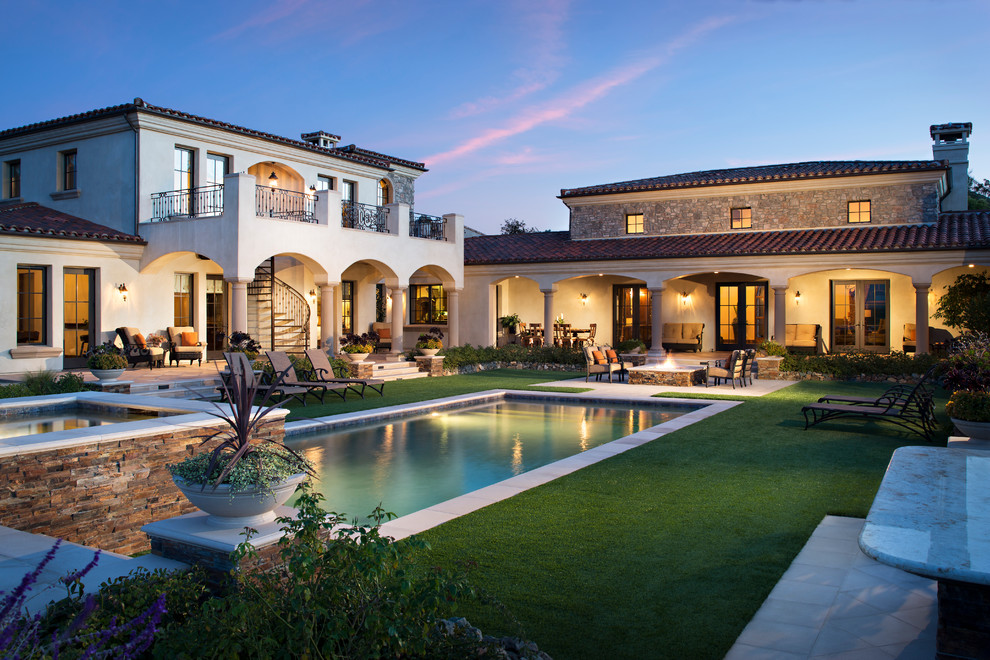 Inspiration for a large and beige mediterranean two floor render house exterior in San Diego with a hip roof.