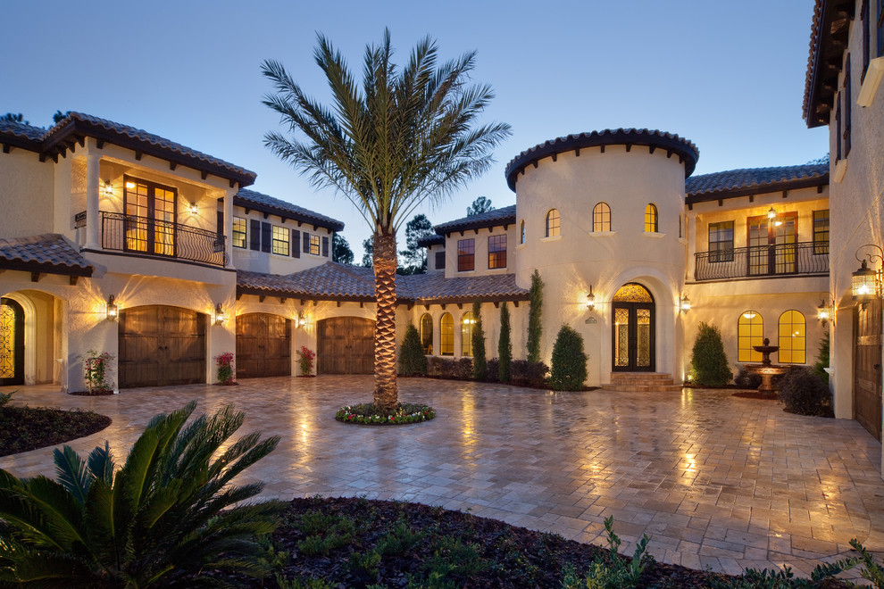 Large tuscan two-story exterior home photo in Orlando