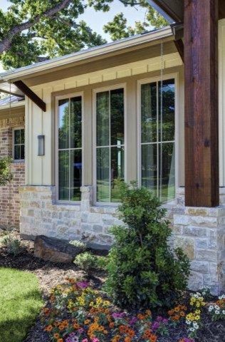 Design ideas for a large and beige traditional bungalow brick house exterior in Dallas.