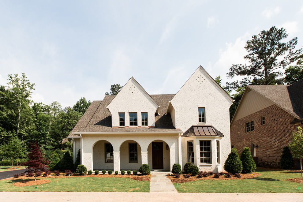 Inspiration for a transitional white two-story brick exterior home remodel in Birmingham with a shingle roof