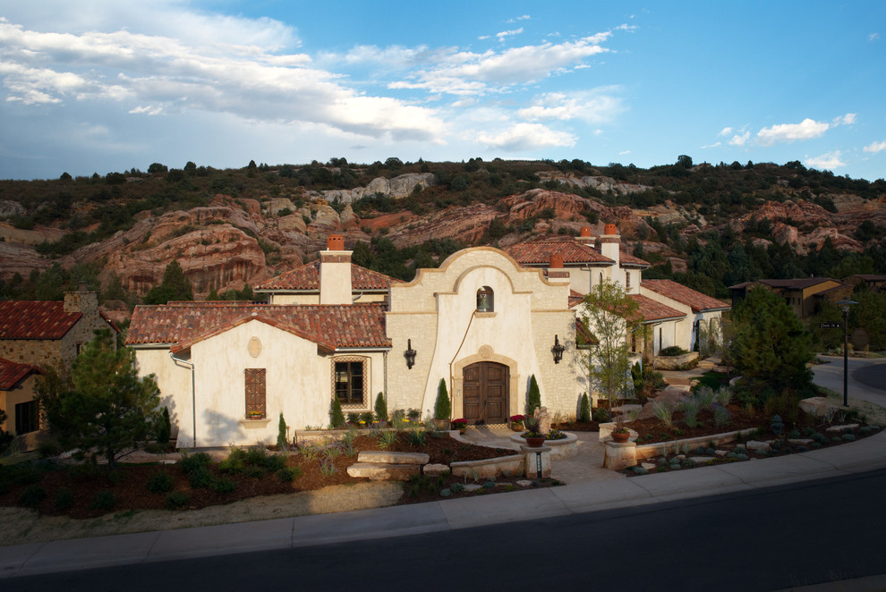 Inspiration for a large and white mediterranean two floor render house exterior in Denver.