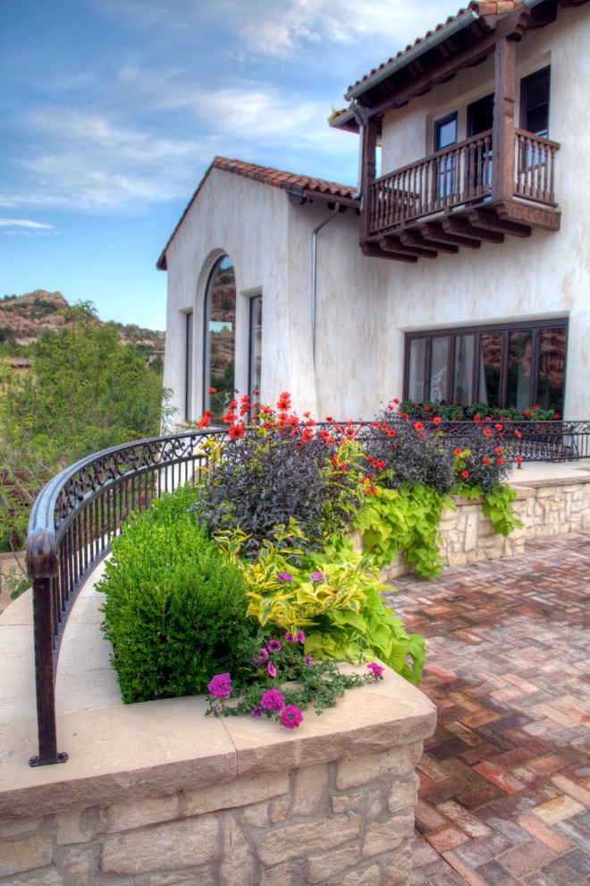Inspiration for a large mediterranean white two-story stucco exterior home remodel in Denver