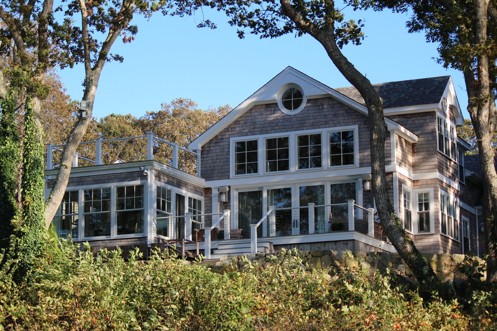 Large beach style gray two-story wood exterior home photo in Boston with a shingle roof