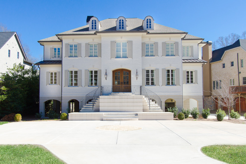 This is an example of a white classic two floor brick house exterior in Atlanta.