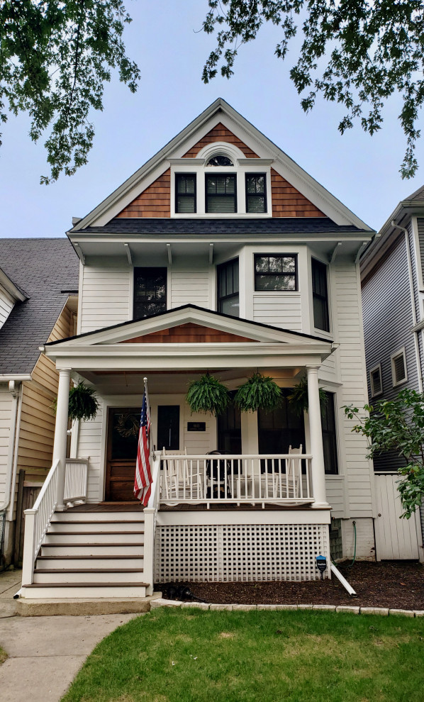 Photo of a large and beige victorian detached house in Chicago with three floors, mixed cladding, a pitched roof and a mixed material roof.