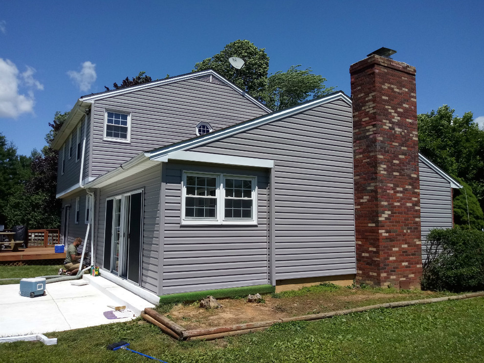 Large elegant gray two-story vinyl exterior home photo in Baltimore with a shingle roof