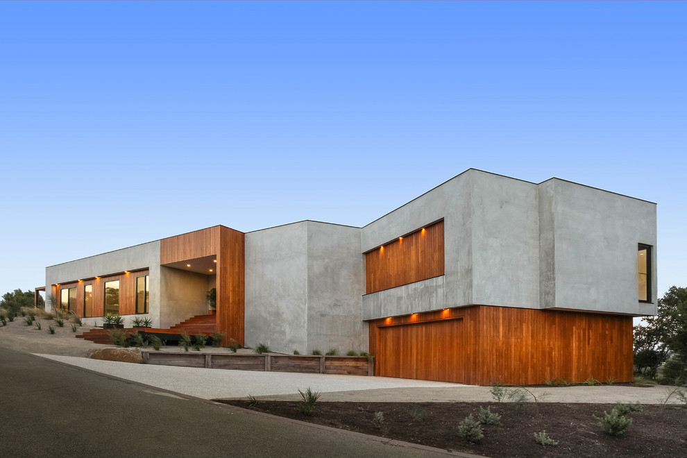 Cette photo montre une façade de maison multicolore tendance à un étage avec un revêtement mixte et un toit plat.