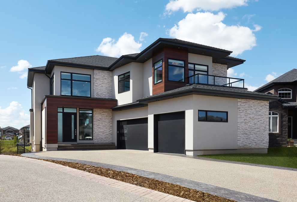 Design ideas for a large and beige contemporary two floor render detached house in Edmonton with a pitched roof and a shingle roof.