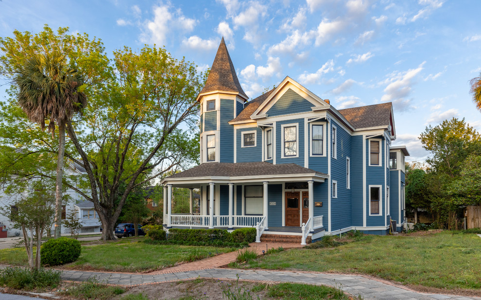 Inspiration for a huge victorian blue three-story wood exterior home remodel in Other with a shingle roof