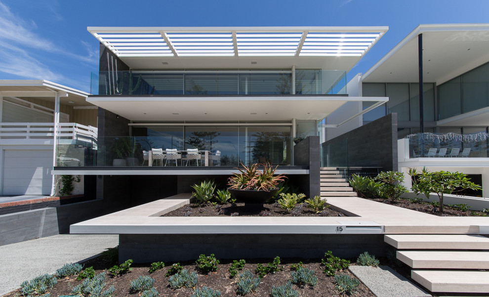 Inspiration for a contemporary house exterior in Perth with three floors.