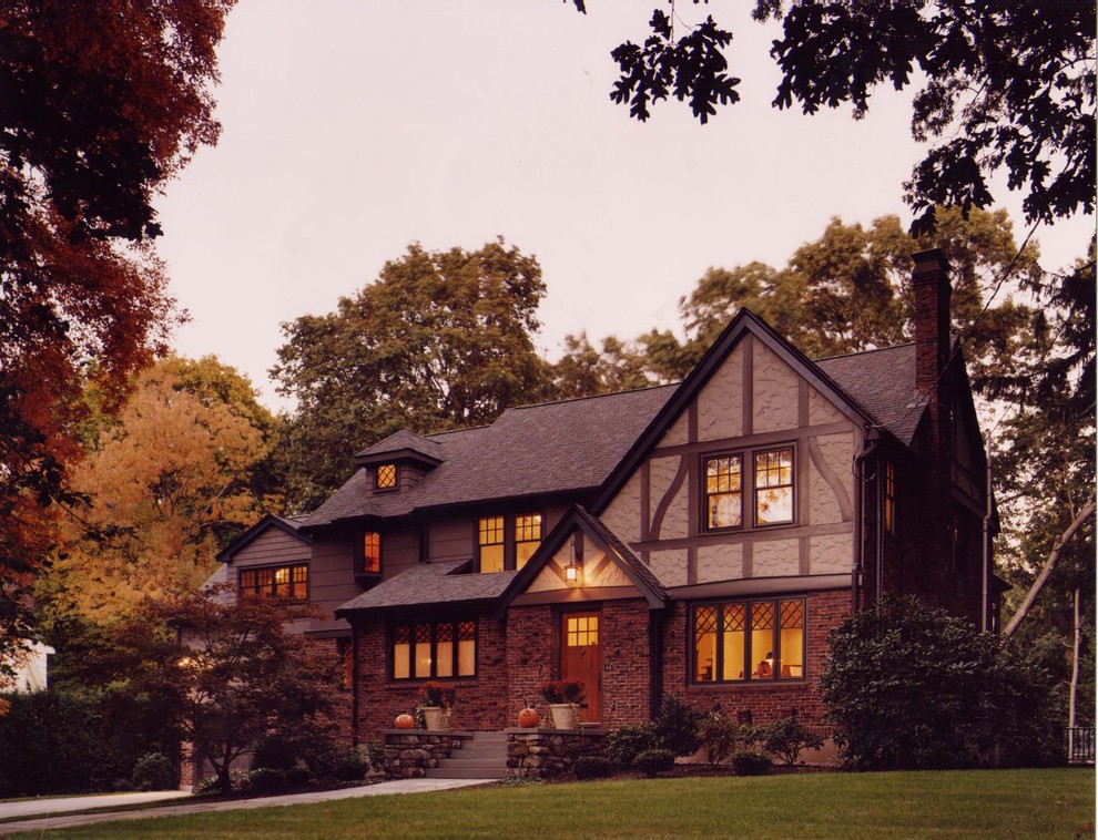 Inspiration for a large timeless brown two-story mixed siding gable roof remodel in Boston