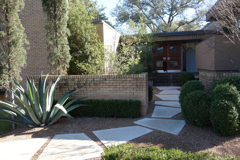 This is an example of a large and brown modern two floor brick detached house in Austin with a flat roof.