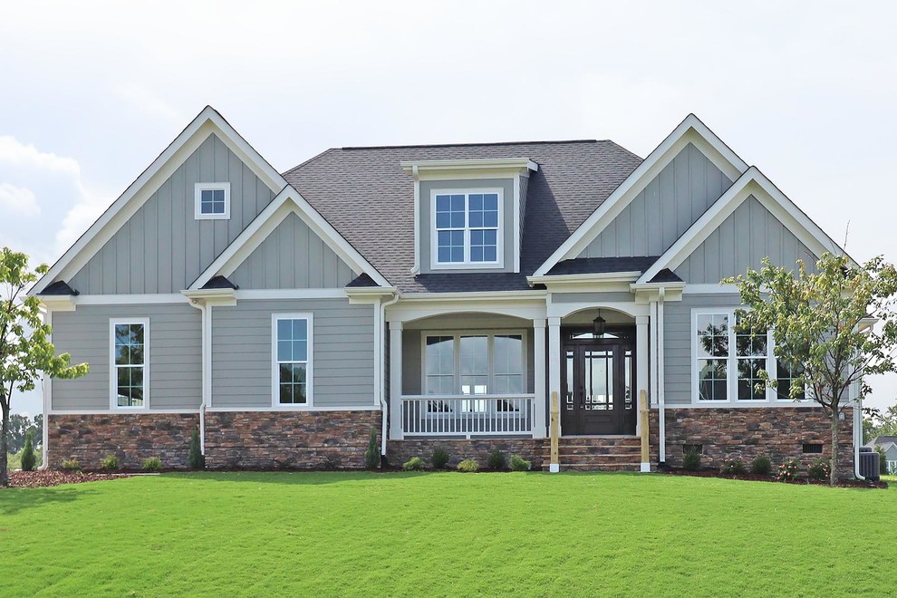 Example of a mid-sized classic gray two-story concrete fiberboard exterior home design in Raleigh with a shingle roof