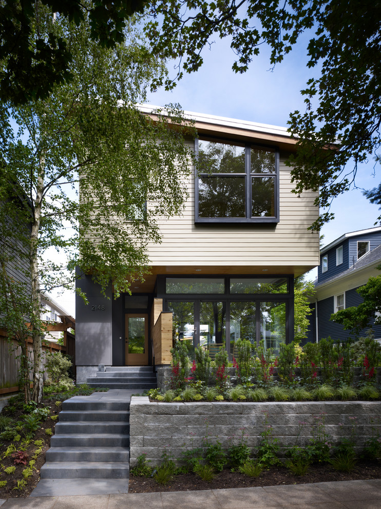 Photo of a modern house exterior in Seattle with wood cladding and a lean-to roof.