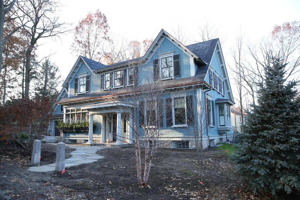 Large elegant blue three-story wood house exterior photo in Boston