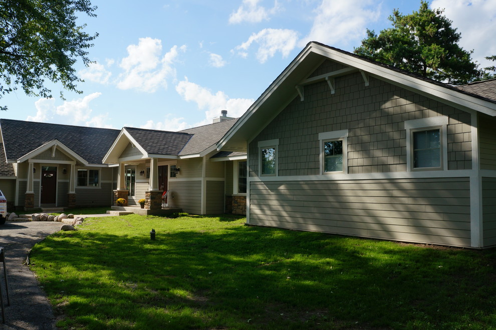 Large traditional bungalow house exterior in Milwaukee with concrete fibreboard cladding and a pitched roof.