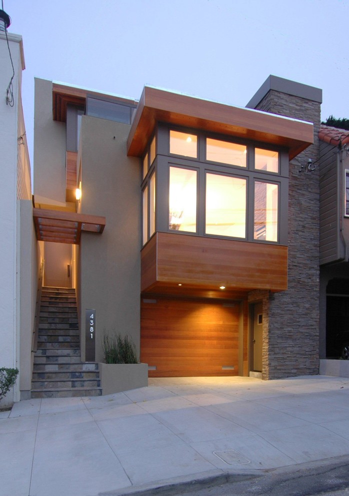 Idée de décoration pour une grande façade de maison grise design à deux étages et plus avec un revêtement mixte.