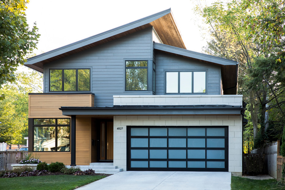 Large trendy gray two-story mixed siding house exterior photo in Chicago with a shed roof and a metal roof