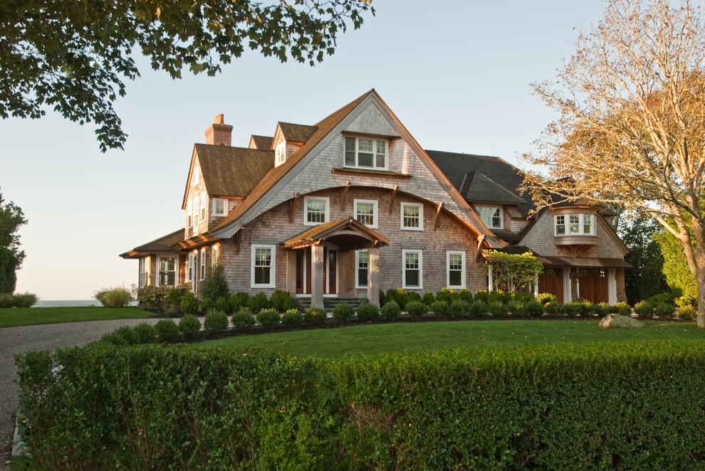 Immagine della facciata di una casa marrone stile marinaro con rivestimento in legno e tetto a capanna
