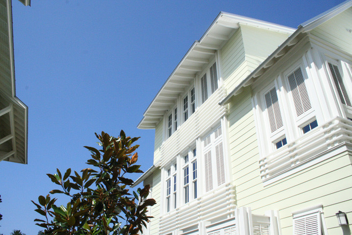 Design ideas for a green nautical house exterior in Miami with wood cladding.