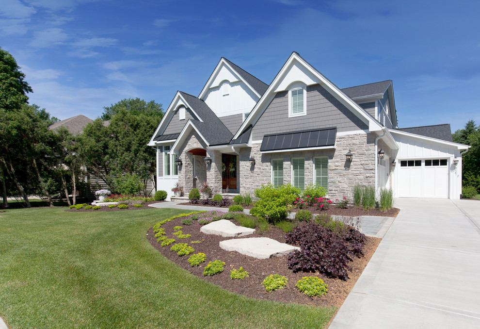 Example of a large transitional multicolored two-story stone exterior home design in Chicago with a shingle roof