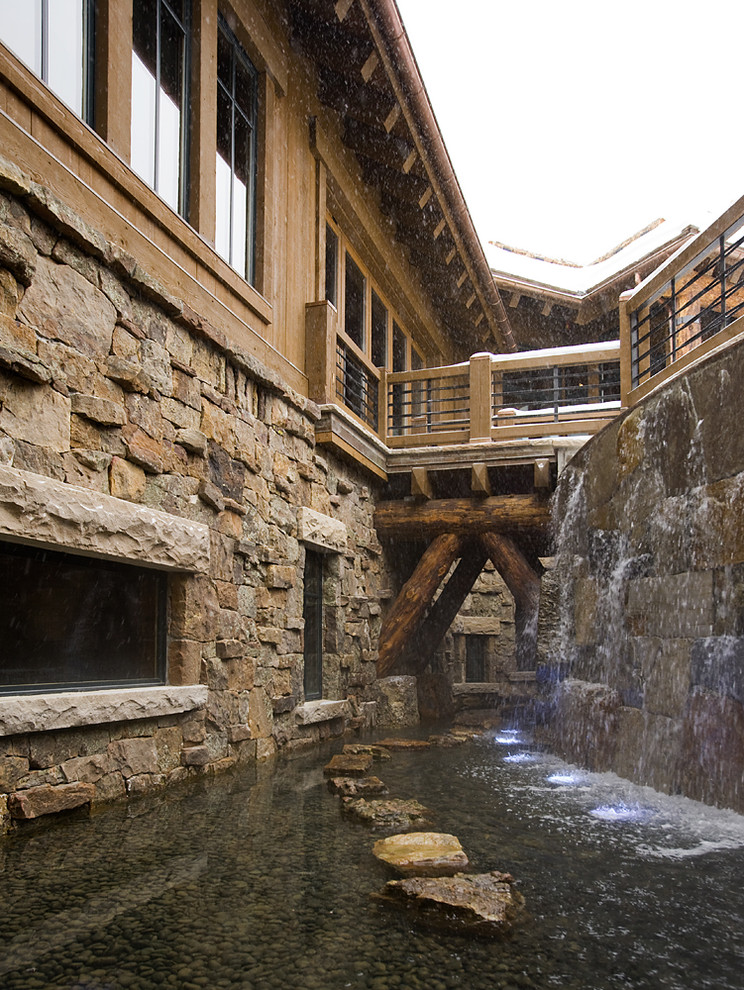 This is an example of a rustic house exterior in Minneapolis with stone cladding.