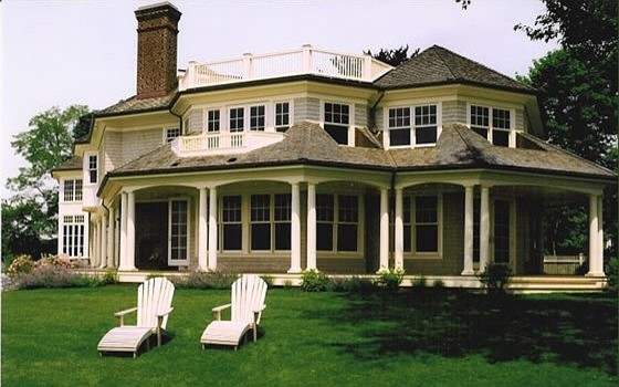 Large elegant beige three-story mixed siding exterior home photo in New York
