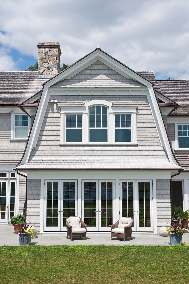 Inspiration for a large timeless gray three-story wood house exterior remodel in New York with a gambrel roof and a shingle roof