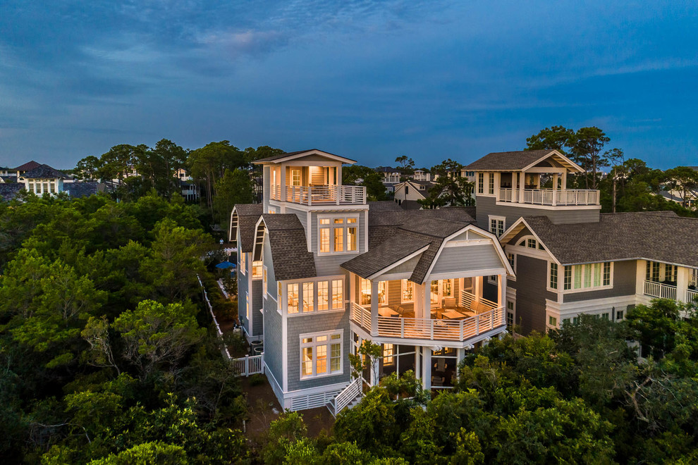 Huge beach style blue three-story house exterior photo in Other with a gambrel roof