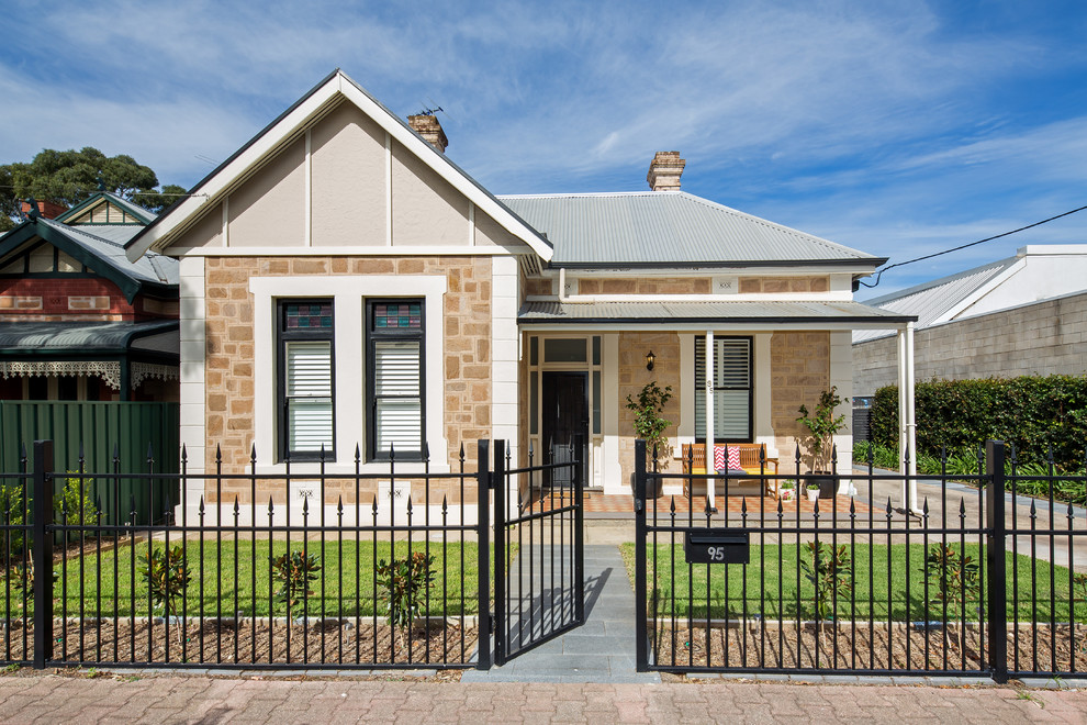 Inspiration for a traditional bungalow house exterior in Adelaide with stone cladding.