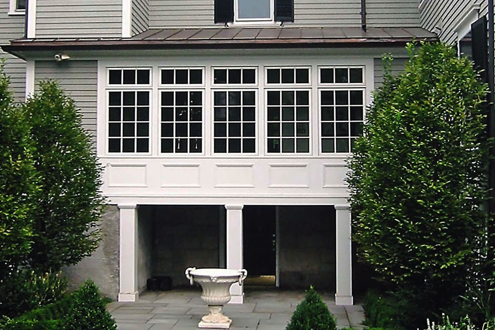 Large traditional gray three-story wood house exterior idea in Boston with a shed roof and a metal roof