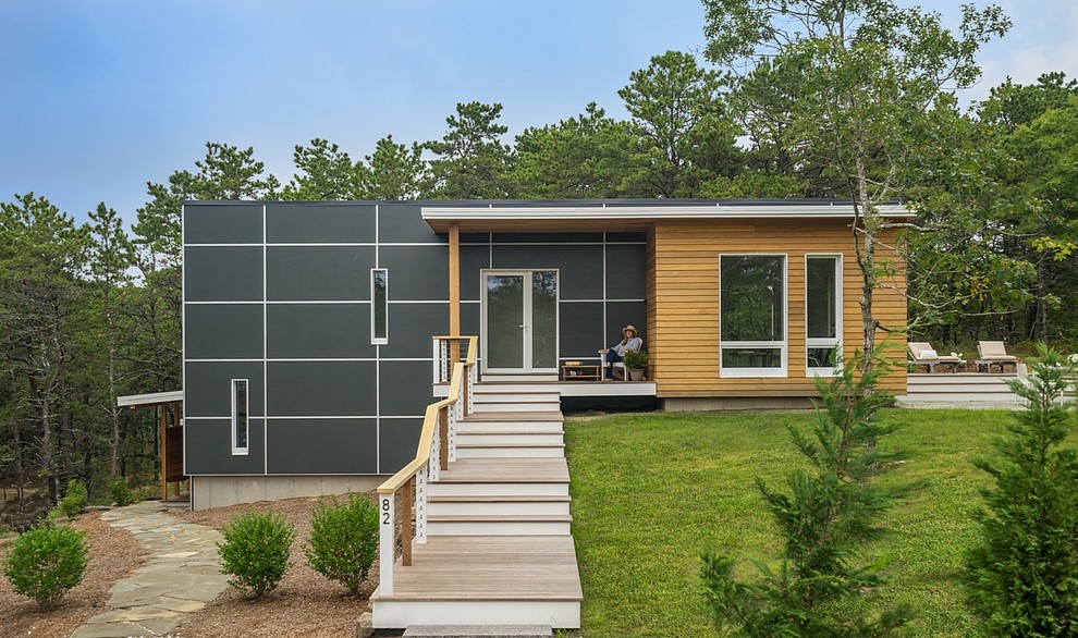 Example of a small trendy black two-story mixed siding exterior home design in Boston